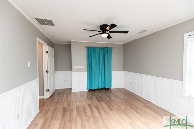 204 Archibald St, Rincon, GA 31326 - spare room with a ceiling fan, wainscoting, wood finished floors, and ornamental molding