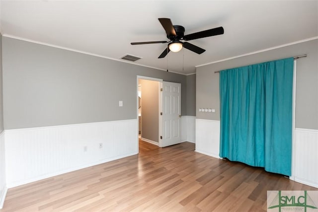 204 Archibald St, Rincon, GA 31326 - spare room featuring ceiling fan, a wainscoted wall, wood finished floors, and crown molding