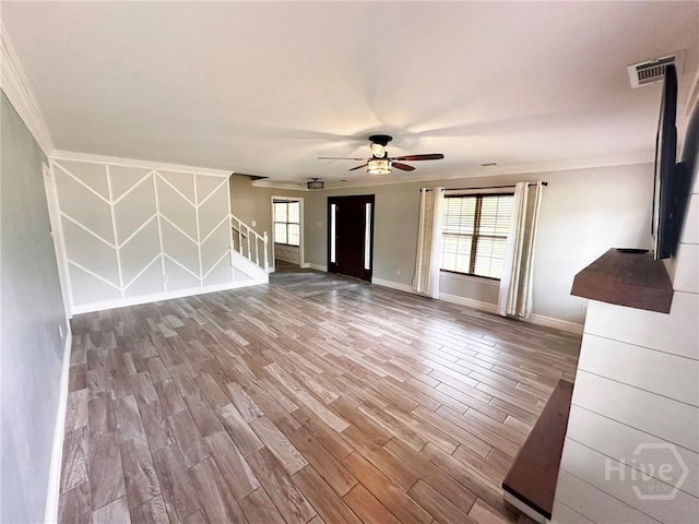 204 Archibald St, Rincon, GA 31326 - unfurnished living room featuring baseboards, wood finished floors, crown molding, ceiling fan, and stairway