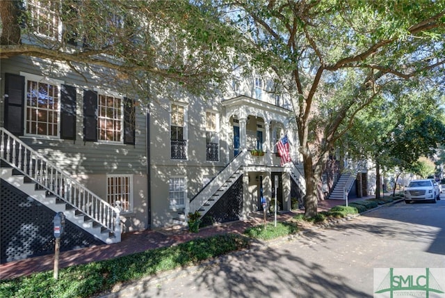 view of front of property with stairs and covered porch