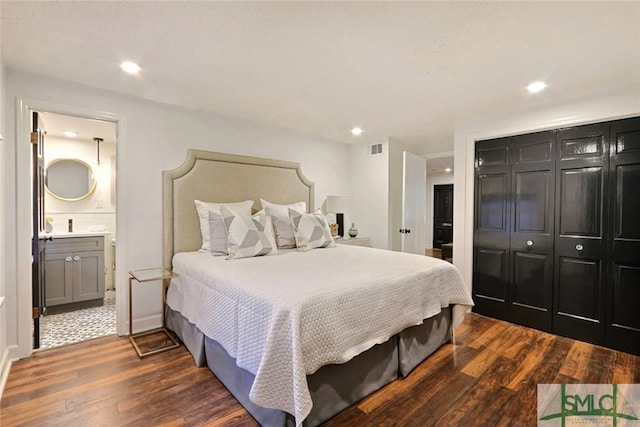 bedroom featuring recessed lighting, visible vents, dark wood-style floors, and ensuite bath