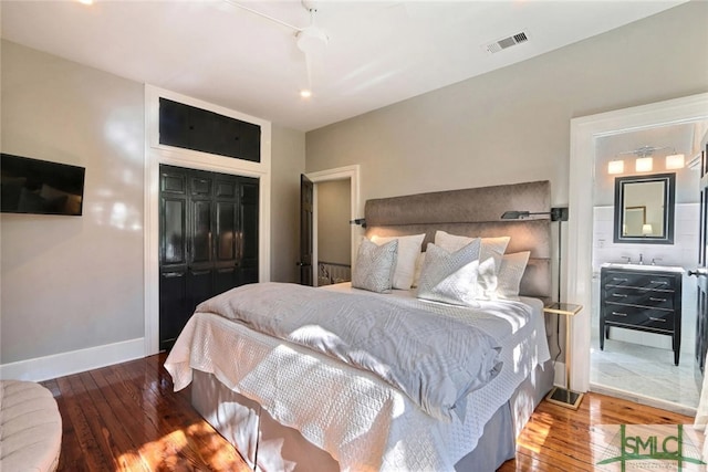 bedroom featuring visible vents, baseboards, a closet, and hardwood / wood-style floors