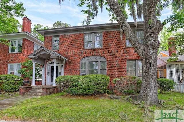 724 E 49th St, Savannah, GA 31405 - view of front of property featuring a front lawn and brick siding