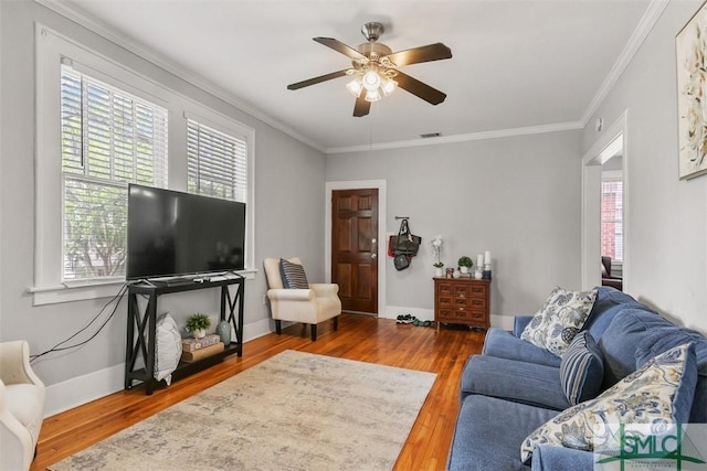724 E 49th St, Savannah, GA 31405 - living area with visible vents, ornamental molding, wood finished floors, baseboards, and a ceiling fan