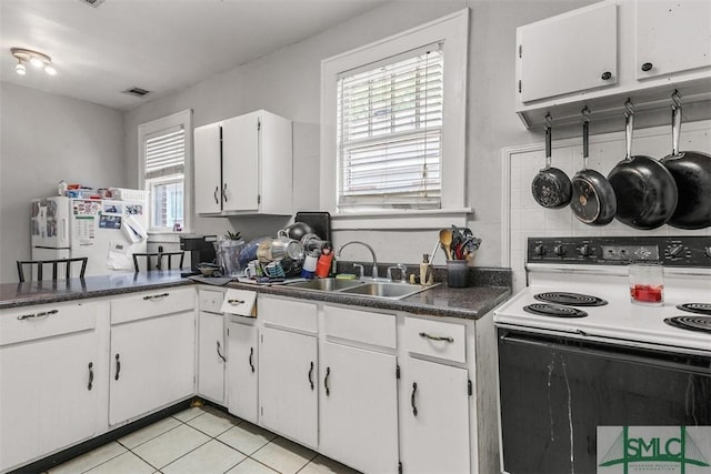 724 E 49th St, Savannah, GA 31405 - kitchen featuring electric range, visible vents, a sink, freestanding refrigerator, and white cabinetry