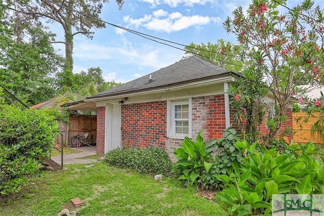 724 E 49th St, Savannah, GA 31405 - view of property exterior featuring brick siding, fence, and a shingled roof