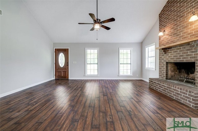 unfurnished living room featuring a ceiling fan, a fireplace, dark wood finished floors, baseboards, and lofted ceiling