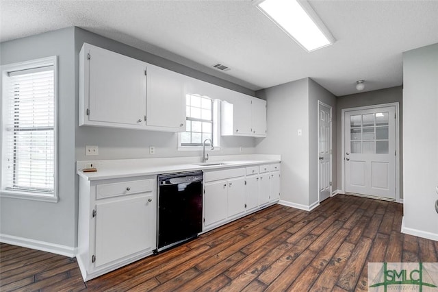 kitchen with a sink, baseboards, visible vents, and dishwasher