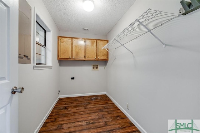 laundry area with washer hookup, a textured ceiling, visible vents, cabinet space, and dark wood-style floors