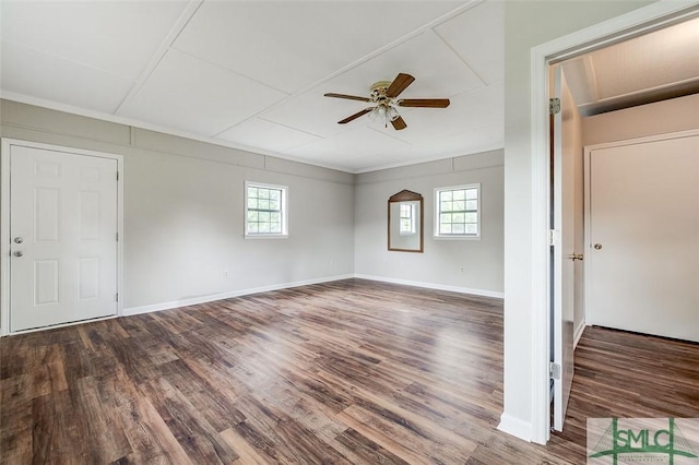 interior space featuring baseboards, ceiling fan, wood finished floors, and a wealth of natural light