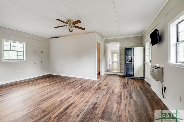 interior space featuring ceiling fan, a wall unit AC, wood finished floors, and plenty of natural light