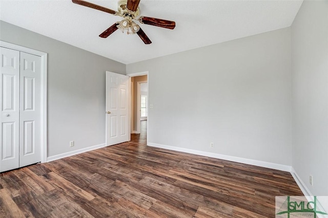 unfurnished bedroom featuring baseboards, a closet, and wood finished floors