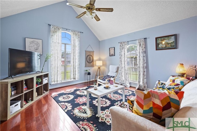 living area featuring a ceiling fan, high vaulted ceiling, plenty of natural light, and wood finished floors