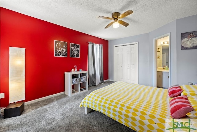 bedroom featuring a closet, a textured ceiling, a ceiling fan, carpet, and ensuite bath