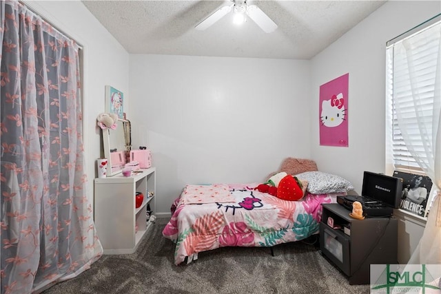 bedroom with carpet floors, ceiling fan, and a textured ceiling