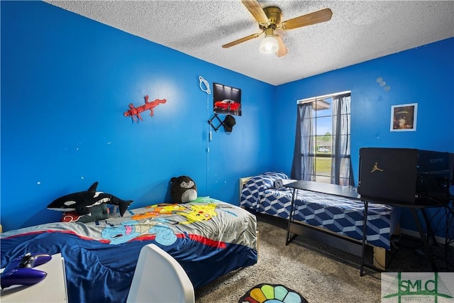 bedroom with a ceiling fan, carpet flooring, and a textured ceiling