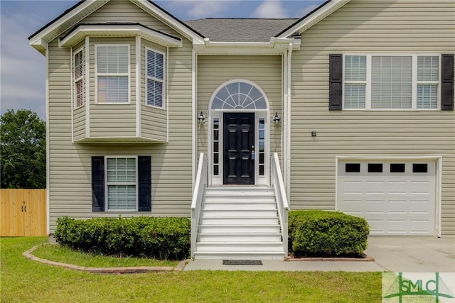 133 Ridgewood Cir, Rincon, GA 31326 - view of front of home featuring an attached garage, roof with shingles, fence, and concrete driveway