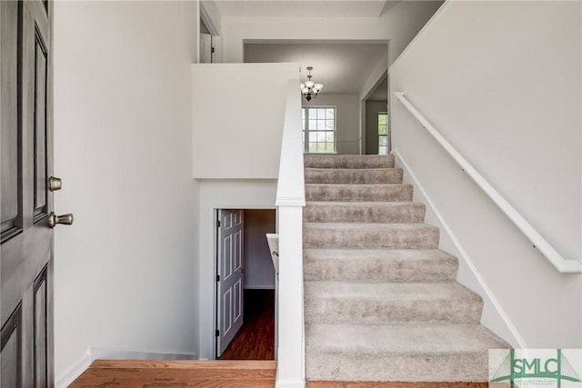 133 Ridgewood Cir, Rincon, GA 31326 - stairway with an inviting chandelier and wood finished floors