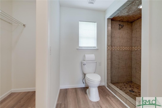 133 Ridgewood Cir, Rincon, GA 31326 - full bath with toilet, visible vents, a tile shower, and wood finished floors