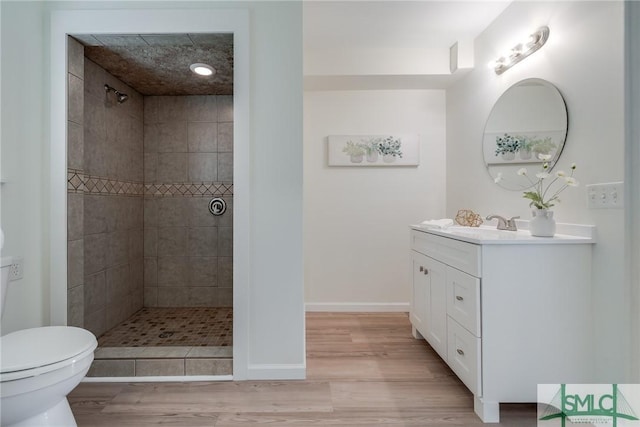 133 Ridgewood Cir, Rincon, GA 31326 - bathroom with vanity, toilet, tiled shower, and wood finished floors