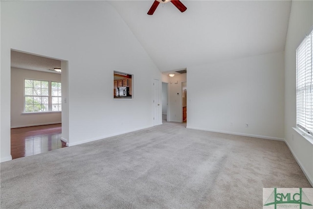 133 Ridgewood Cir, Rincon, GA 31326 - unfurnished living room with a ceiling fan, high vaulted ceiling, baseboards, and carpet