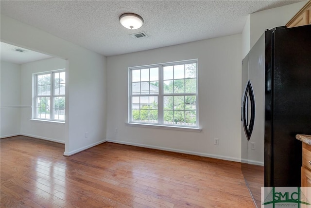 133 Ridgewood Cir, Rincon, GA 31326 - unfurnished dining area featuring plenty of natural light, baseboards, visible vents, and light wood-type flooring