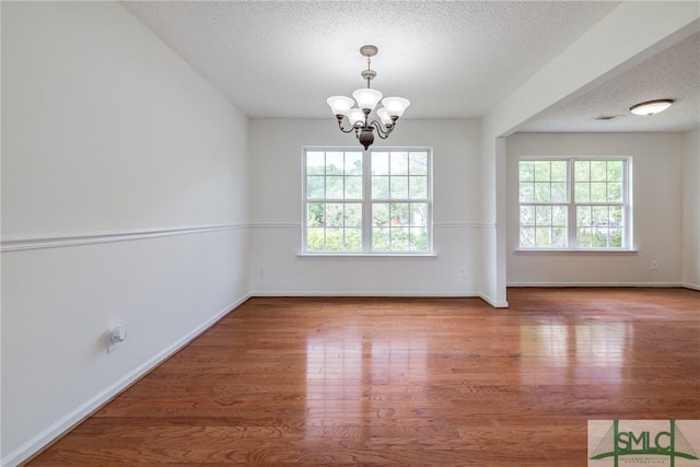 133 Ridgewood Cir, Rincon, GA 31326 - unfurnished dining area featuring a textured ceiling, a chandelier, and a healthy amount of sunlight