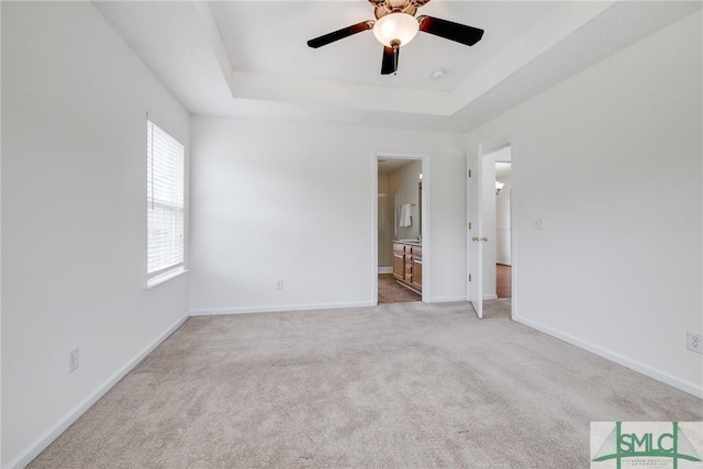 133 Ridgewood Cir, Rincon, GA 31326 - unfurnished room featuring baseboards, a tray ceiling, light carpet, and ceiling fan