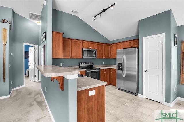 169 Nandina Way, Pooler, GA 31322 - kitchen with visible vents, a peninsula, brown cabinets, and stainless steel appliances