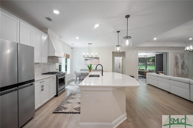 20 Serenity Pt, Savannah, GA 31419 - kitchen featuring visible vents, a chandelier, custom range hood, a sink, and appliances with stainless steel finishes