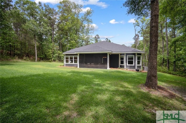 20 Serenity Pt, Savannah, GA 31419 - rear view of house featuring a yard, a shingled roof, and a sunroom