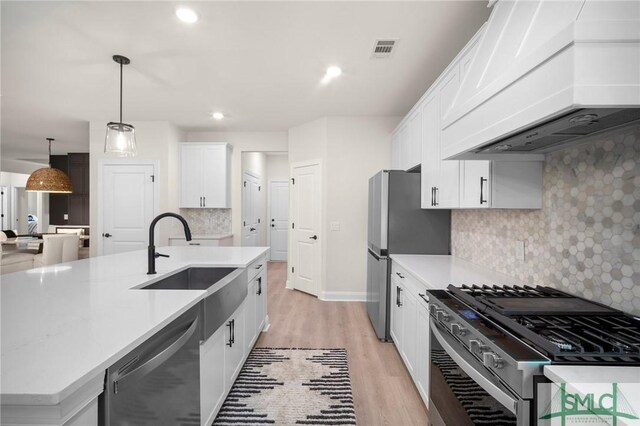 20 Serenity Pt, Savannah, GA 31419 - kitchen with visible vents, appliances with stainless steel finishes, light wood-type flooring, a sink, and premium range hood