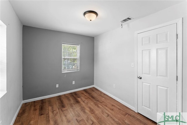 1145 Graydon St, Savannah, GA 31404 - spare room featuring baseboards, wood finished floors, and visible vents