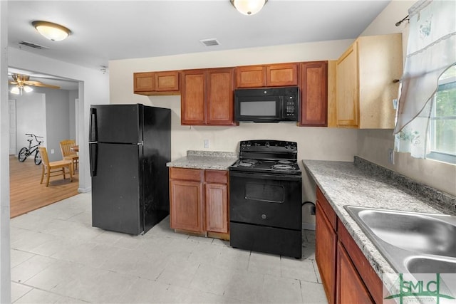 1145 Graydon St, Savannah, GA 31404 - kitchen with visible vents, light countertops, a sink, and black appliances