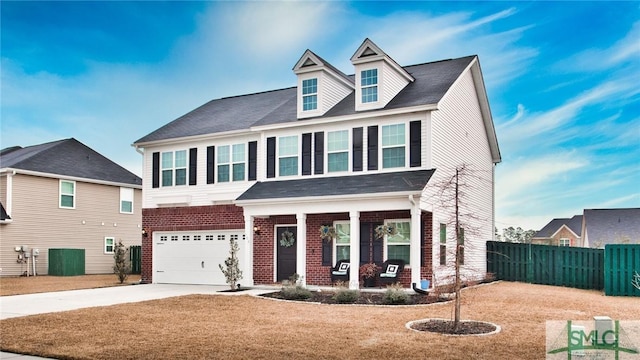 view of front of home featuring fence, covered porch, brick siding, an attached garage, and driveway