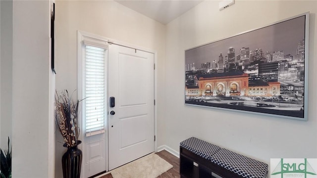 foyer entrance featuring baseboards and wood finished floors