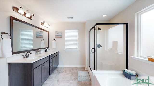 bathroom with a sink, a stall shower, double vanity, and visible vents