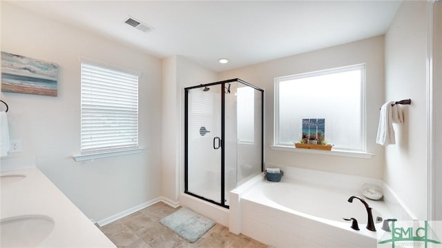 full bathroom with a garden tub, a sink, visible vents, and a shower stall