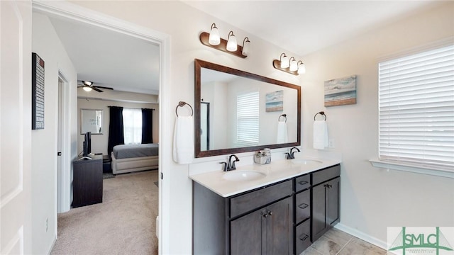 full bath with a sink, a ceiling fan, double vanity, and connected bathroom