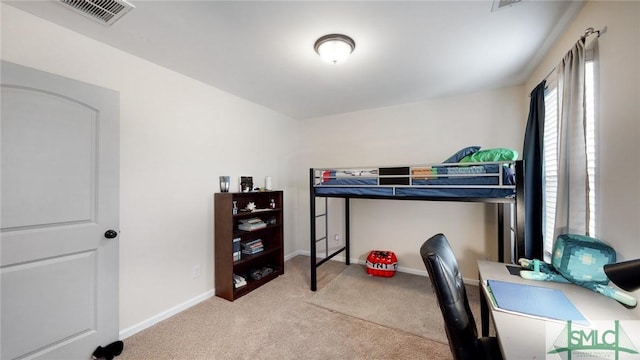 carpeted bedroom featuring baseboards and visible vents