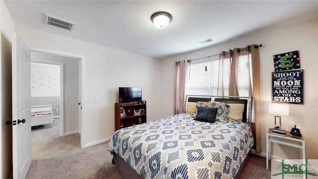 carpeted bedroom featuring baseboards and visible vents