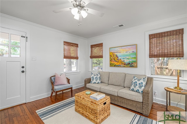 living room featuring a healthy amount of sunlight, baseboards, and wood finished floors