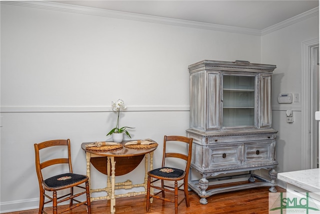 sitting room featuring crown molding and wood finished floors