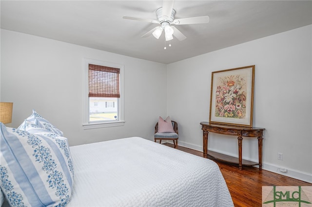 bedroom with baseboards, ceiling fan, and wood finished floors