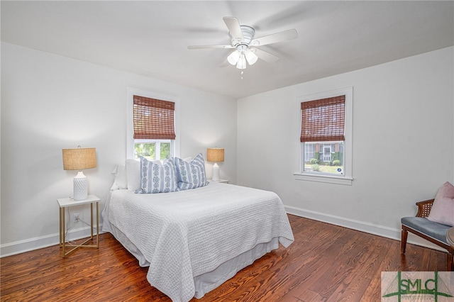 bedroom featuring a ceiling fan, baseboards, and wood finished floors