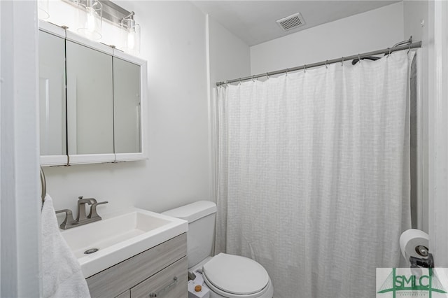 bathroom featuring visible vents, curtained shower, toilet, and vanity