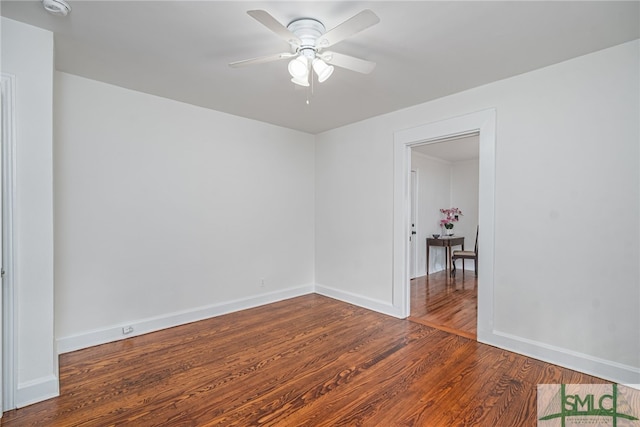 spare room with baseboards, a ceiling fan, and wood finished floors