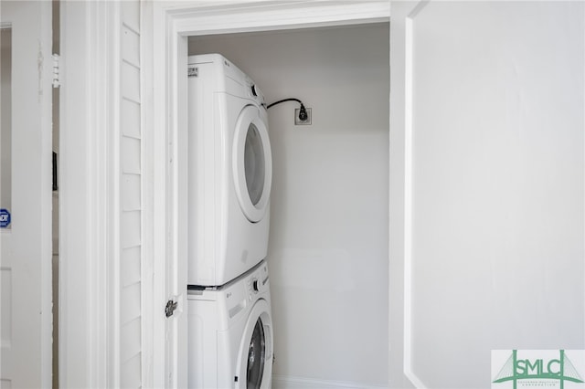 clothes washing area with stacked washer / drying machine