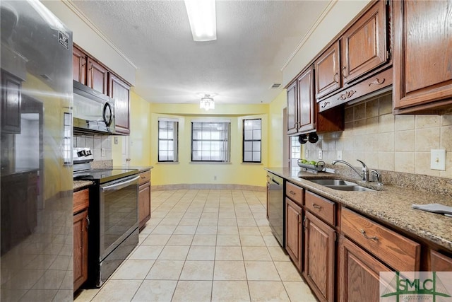 kitchen with visible vents, decorative backsplash, light tile patterned flooring, a sink, and appliances with stainless steel finishes
