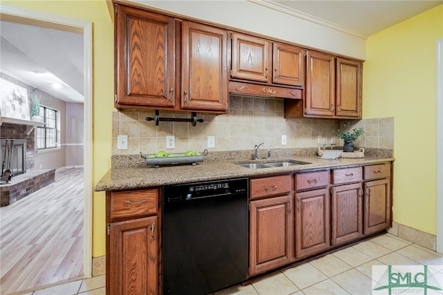 kitchen featuring a sink, decorative backsplash, dishwasher, and brown cabinets